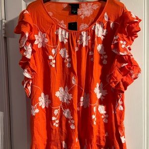 Size 3X orange blouse with decorative embroidered white flowers.